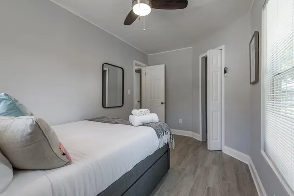 a bedroom with a bed and a chandelier