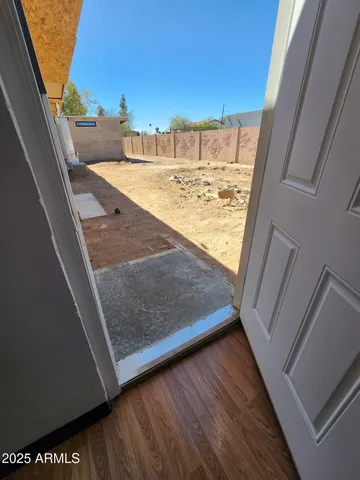 a room with wooden floor and window