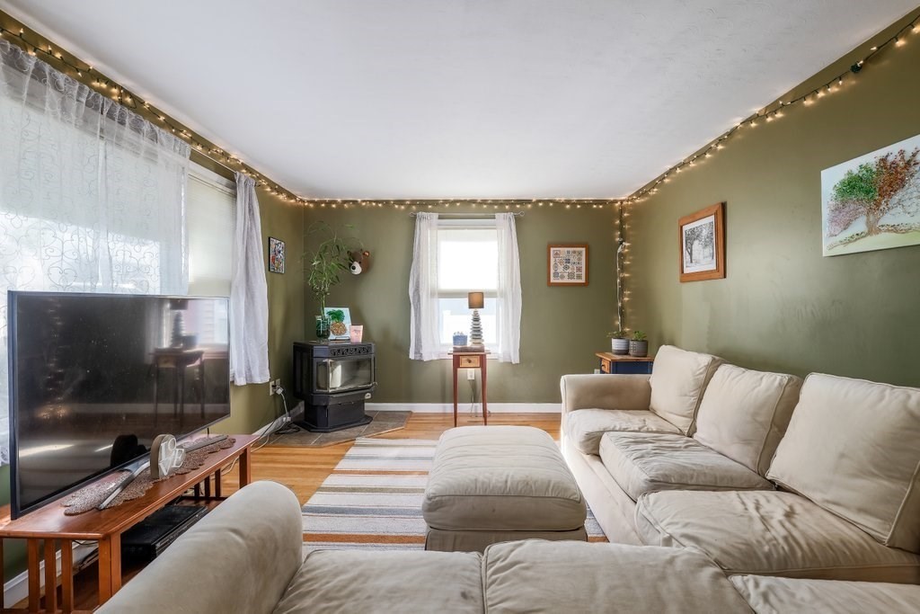83 Stoneleigh Road Holden, MA 01520 - Photo 5 of 14 a living room with furniture and a flat screen tv