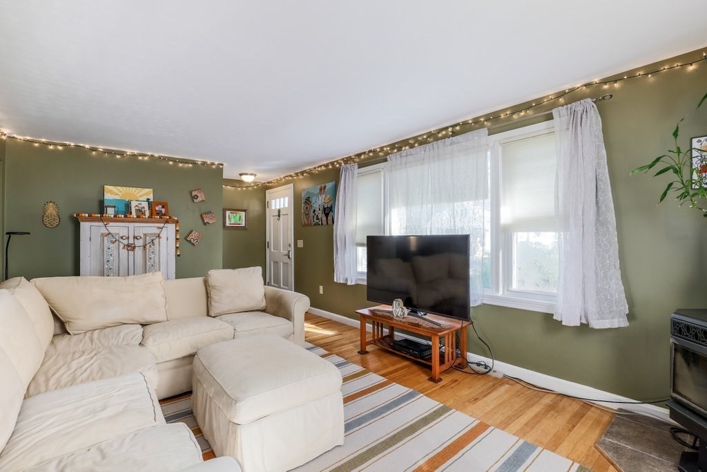 83 Stoneleigh Road Holden, MA 01520 - Photo 6 of 14 a living room with furniture and a flat screen tv