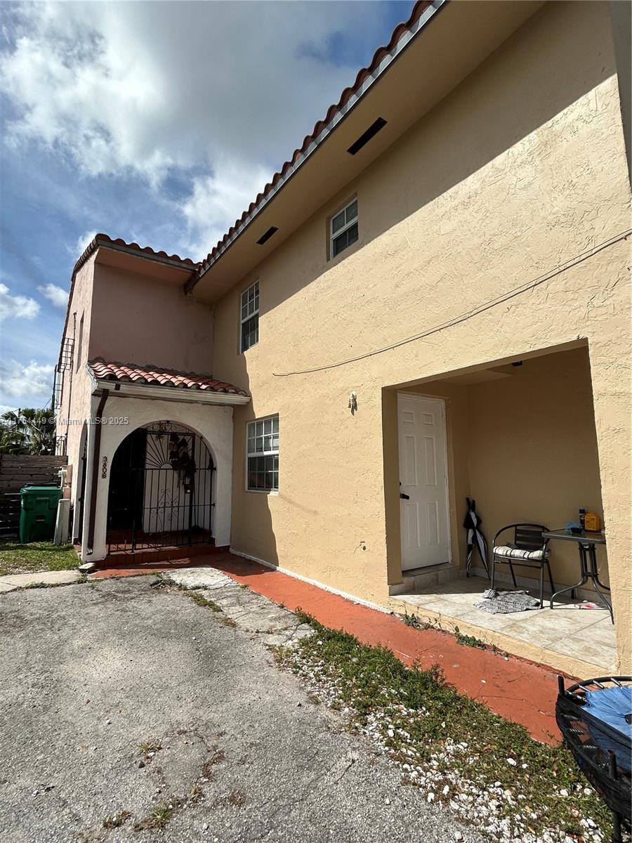 a view of a big room with a fireplace and a chandelier