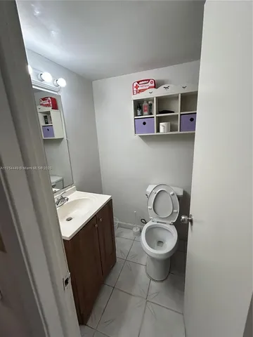 a room with a refrigerator and cabinets