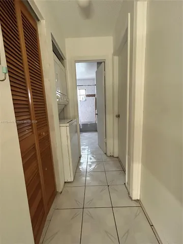 a view of an empty room and wooden floor