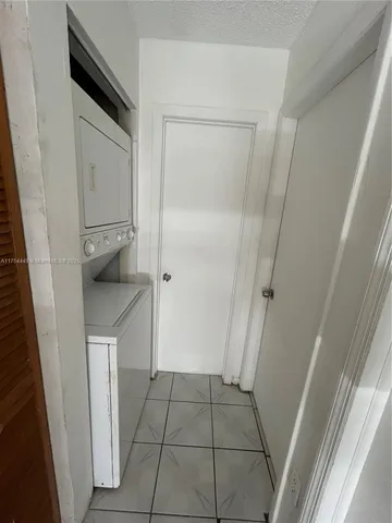 a kitchen with stainless steel appliances a refrigerator sink and white cabinets