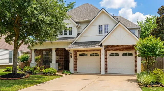 a view of house with yard and front view of a house