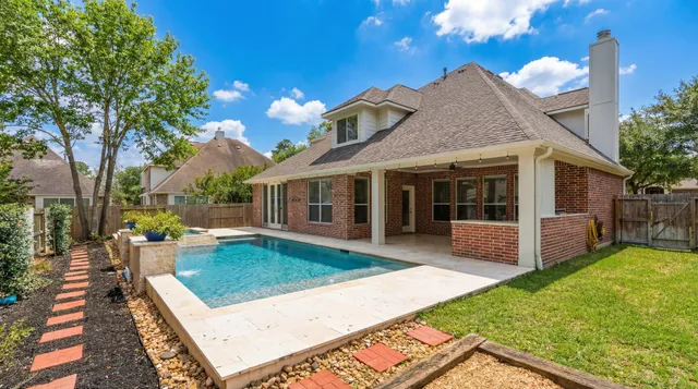 a view of a backyard with a garden and tree