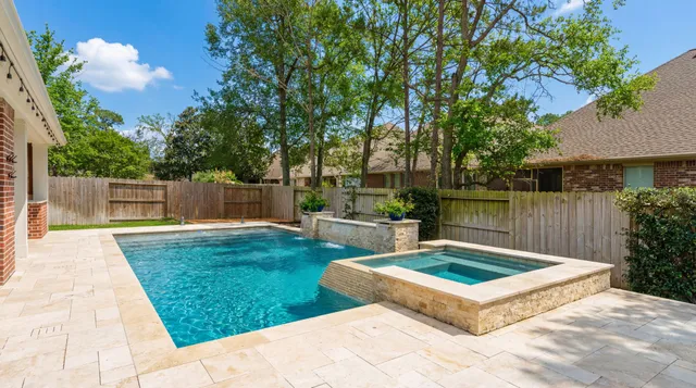 a view of a backyard with large trees