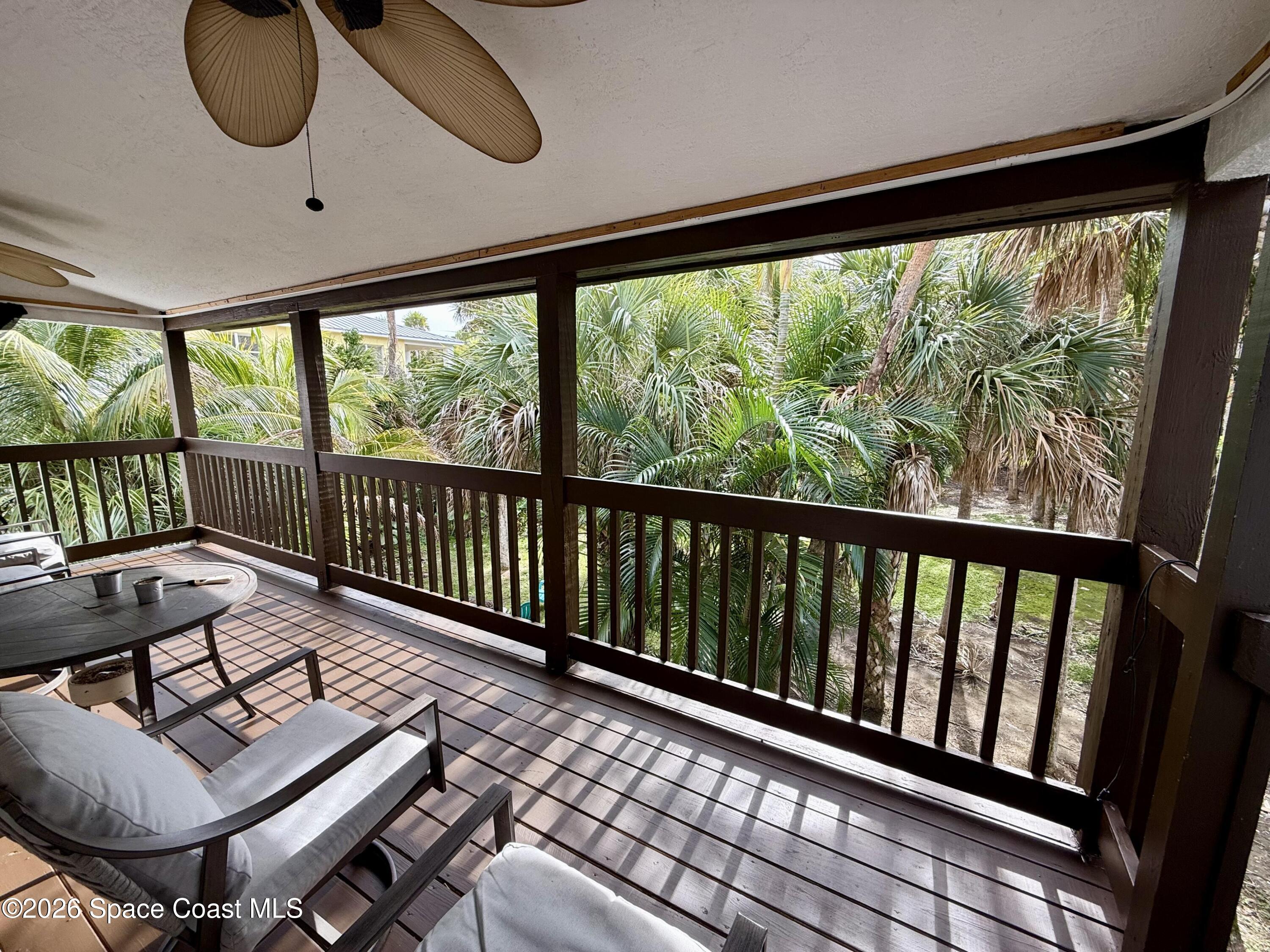 111 Seagrape Road Melbourne Beach, FL 32951 - Photo 12 of 19 a living room with furniture and a floor to ceiling window