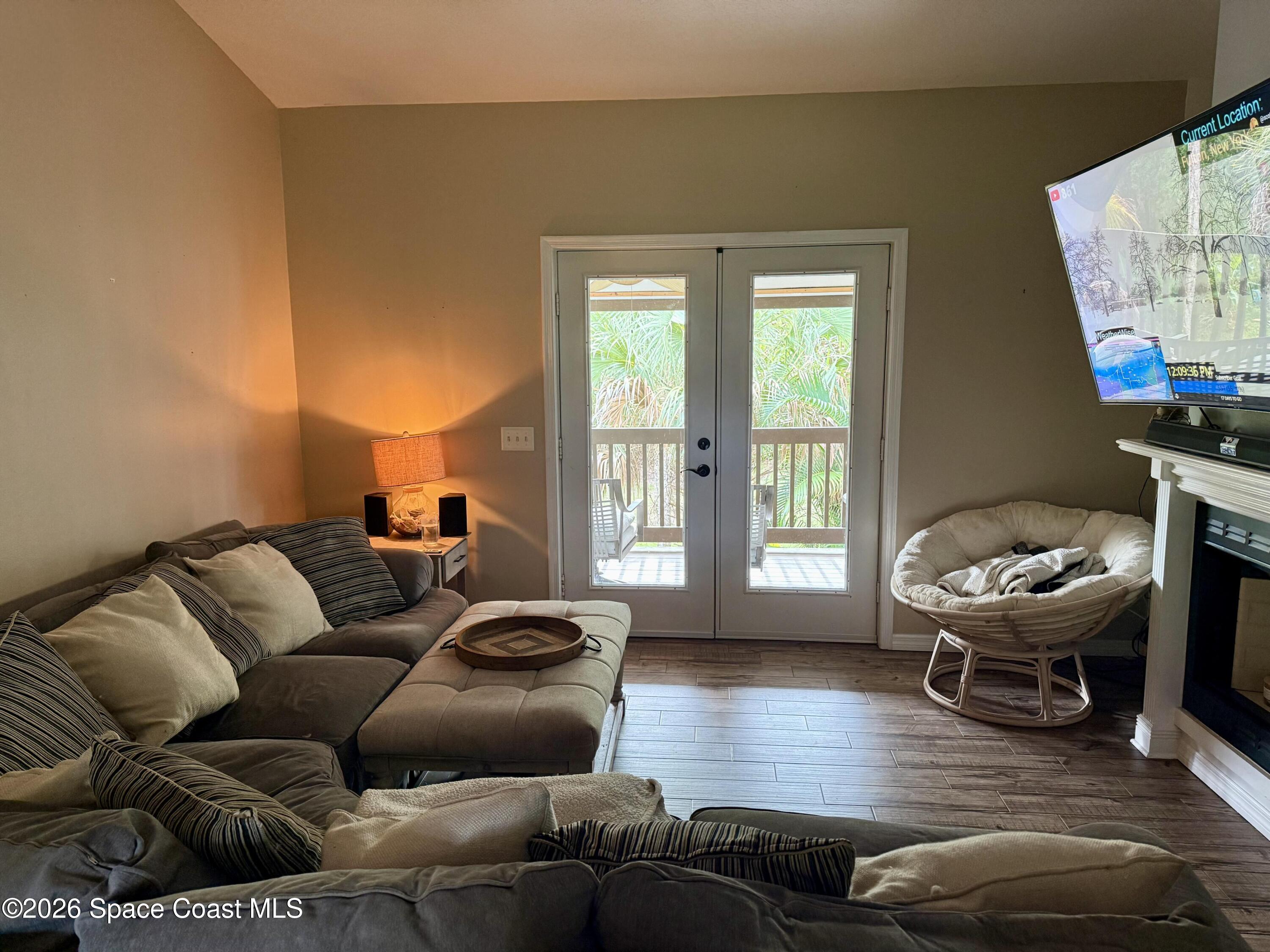 111 Seagrape Road Melbourne Beach, FL 32951 - Photo 14 of 19 a living room with furniture and a flat screen tv