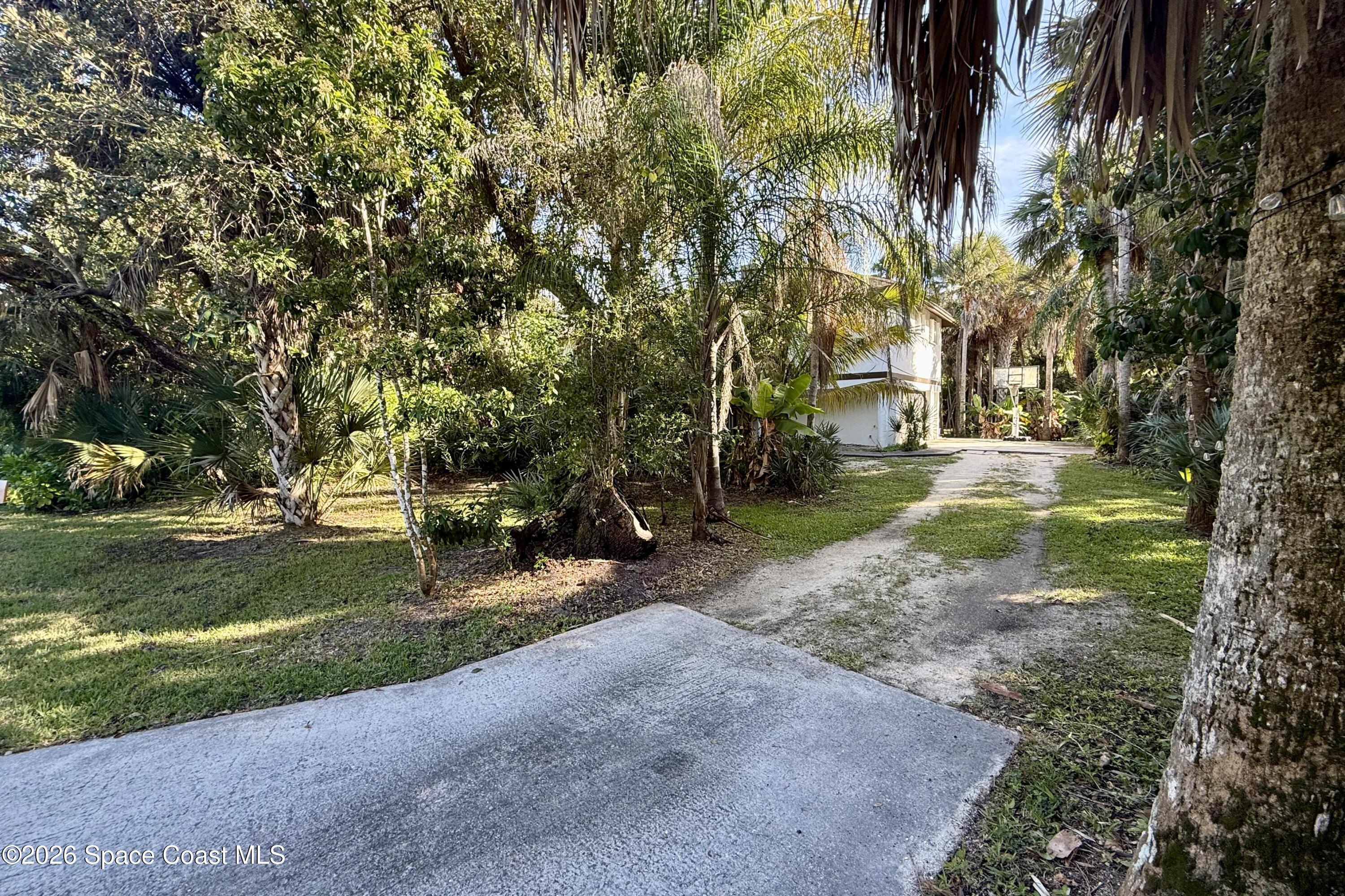 111 Seagrape Road Melbourne Beach, FL 32951 - Photo 2 of 19 a view of a park with large trees