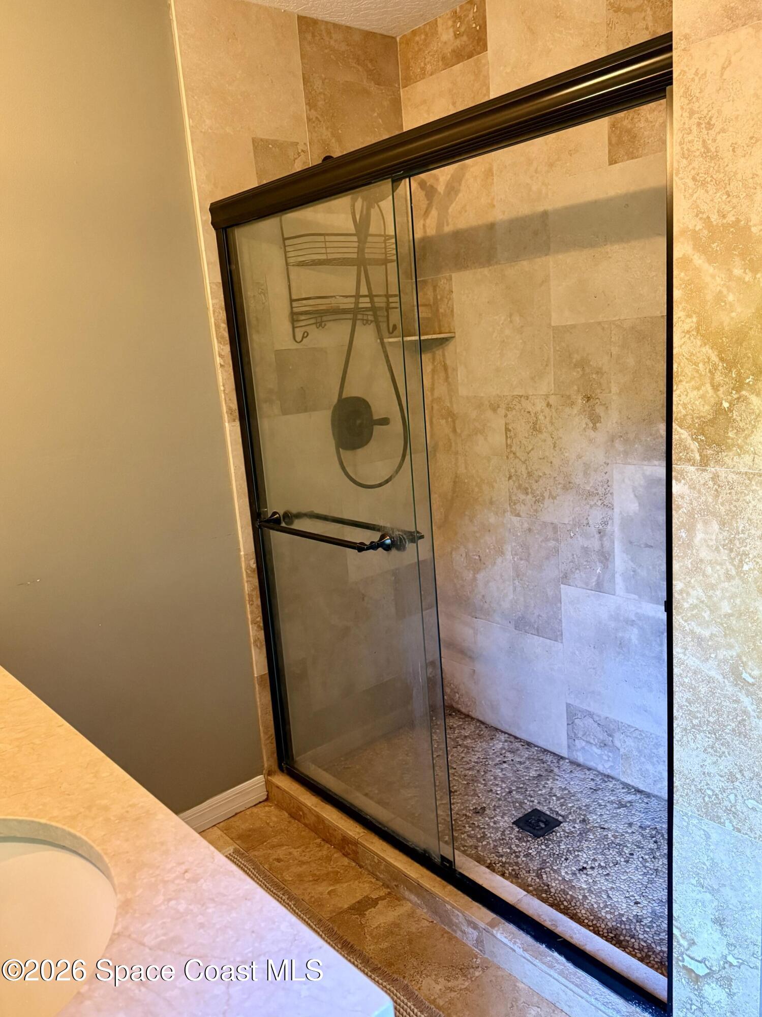 111 Seagrape Road Melbourne Beach, FL 32951 - Photo 9 of 19 a bathroom with a glass shower door