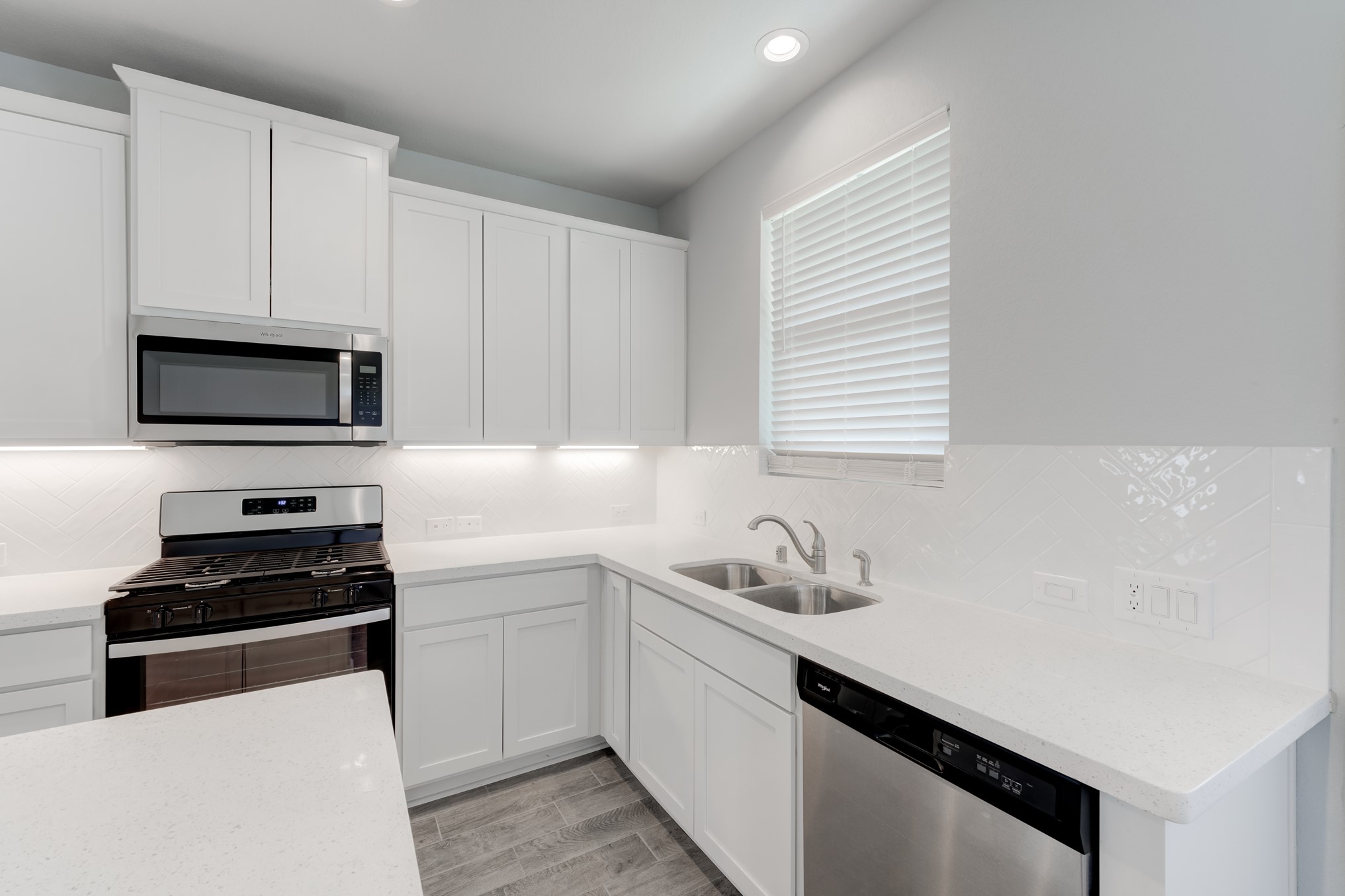 1225 Red Hills Drive Rosharon, TX 77583 - Photo 11 of 27 a kitchen with sink a microwave a stove and cabinets