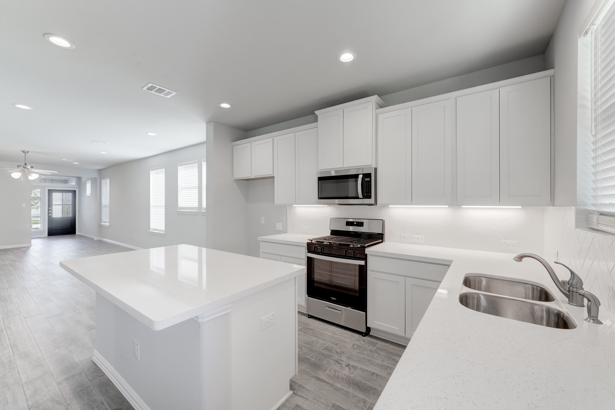 1225 Red Hills Drive Rosharon, TX 77583 - Photo 12 of 27 a large white kitchen with stainless steel appliances granite countertop a sink dishwasher a stove and a refrigerator with wooden floor