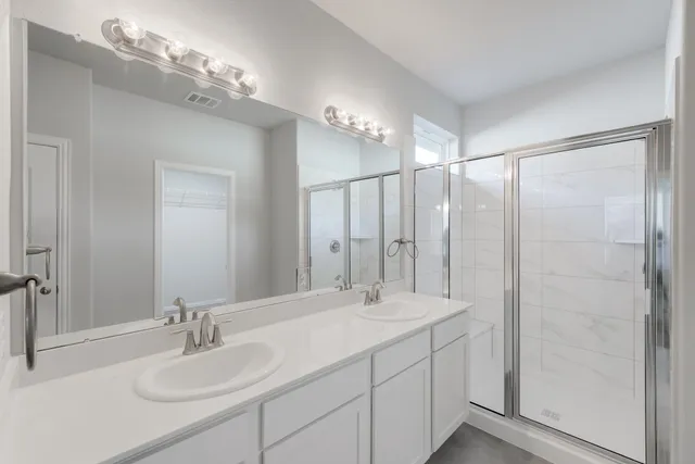 a bathroom with a double vanity sink mirror and double