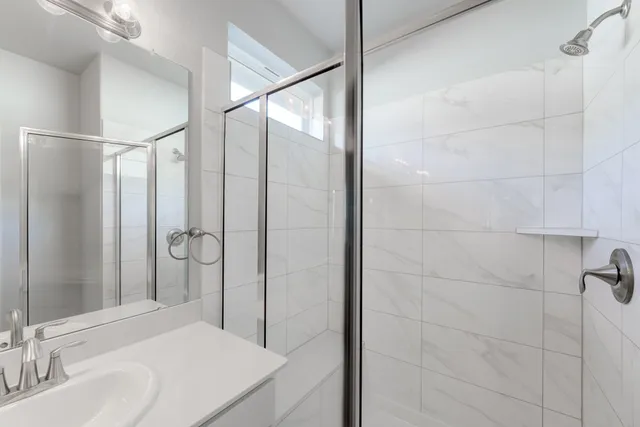 a bathroom with a sink and shower