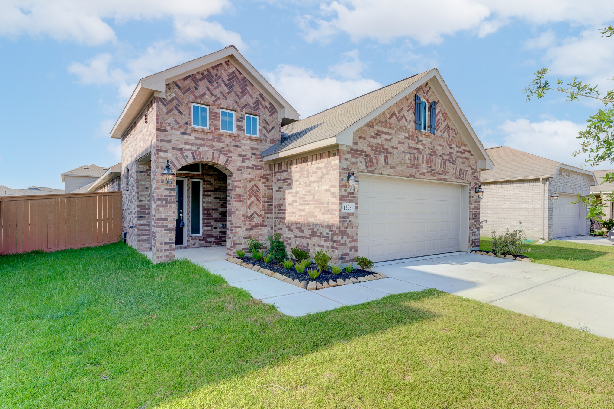 1225 Red Hills Drive Rosharon, TX 77583 - Photo 2 of 27 a front view of a house with a garden and plants