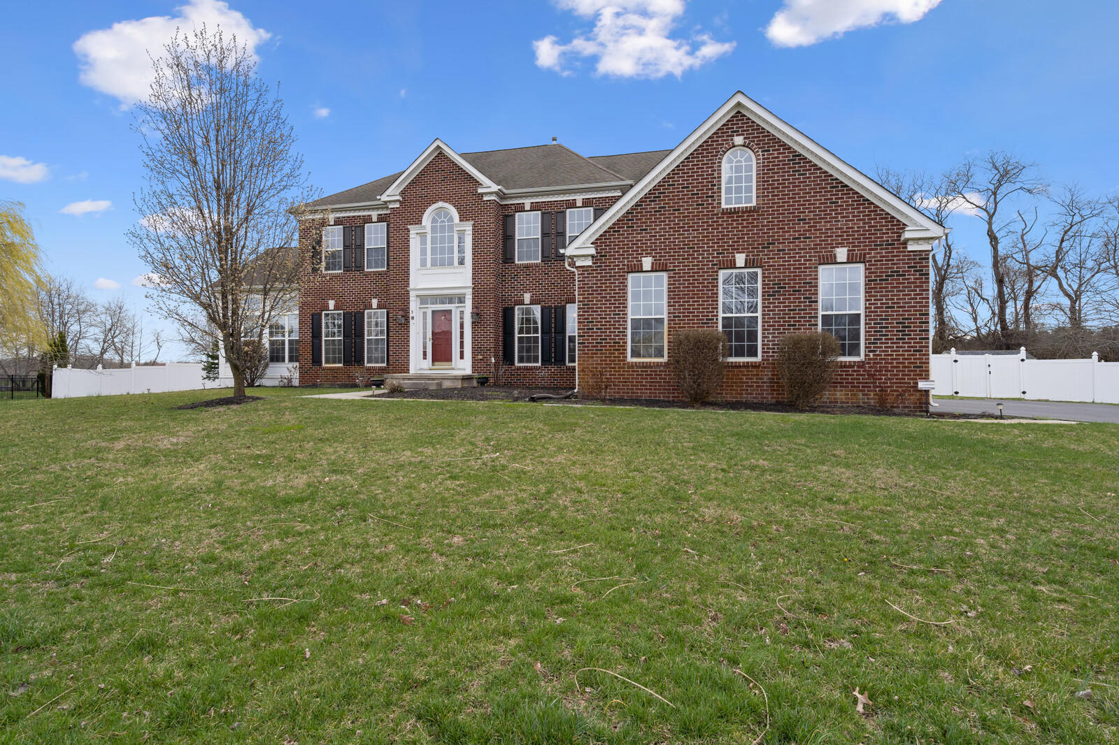 9 Nicholas Court Cream Ridge, NJ 08514 - Photo 5 of 53 a front view of a house with a garden and trees