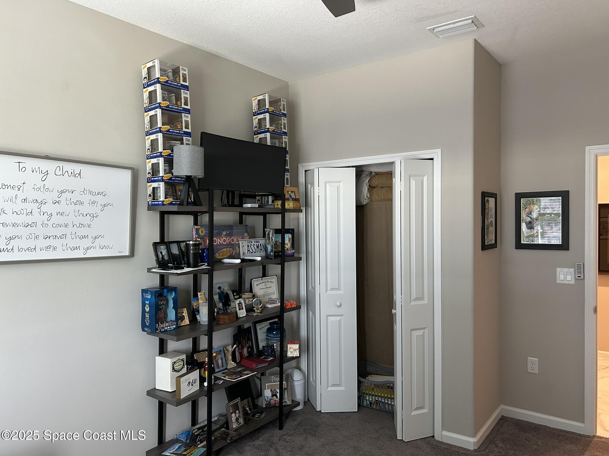 3931 Playa Del Sol Drive, Unit 203 Rockledge, FL 32955 - Photo 19 of 36 a view of a livingroom with shelves