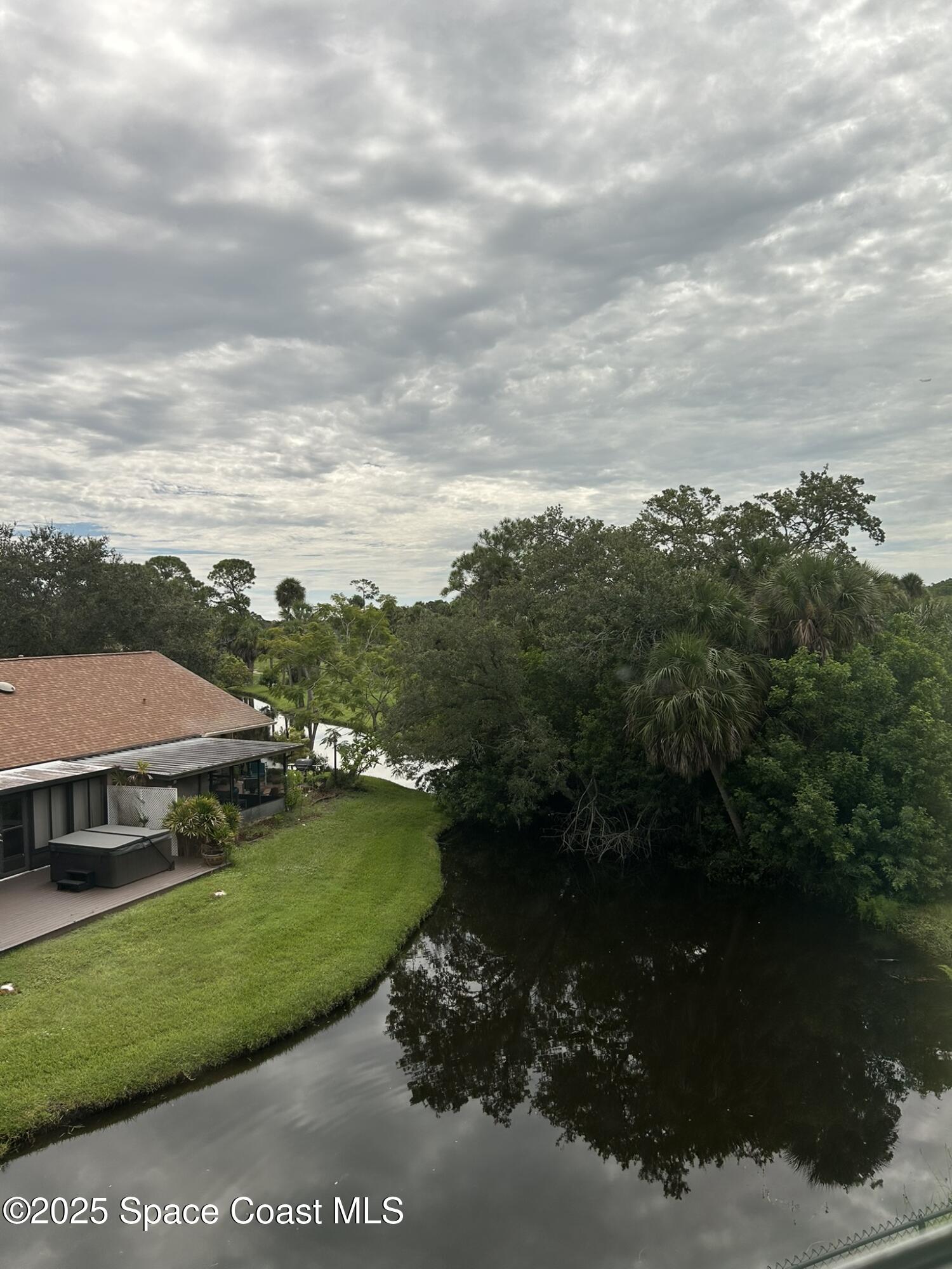 3931 Playa Del Sol Drive, Unit 203 Rockledge, FL 32955 - Photo 20 of 36 a view of a lake with houses