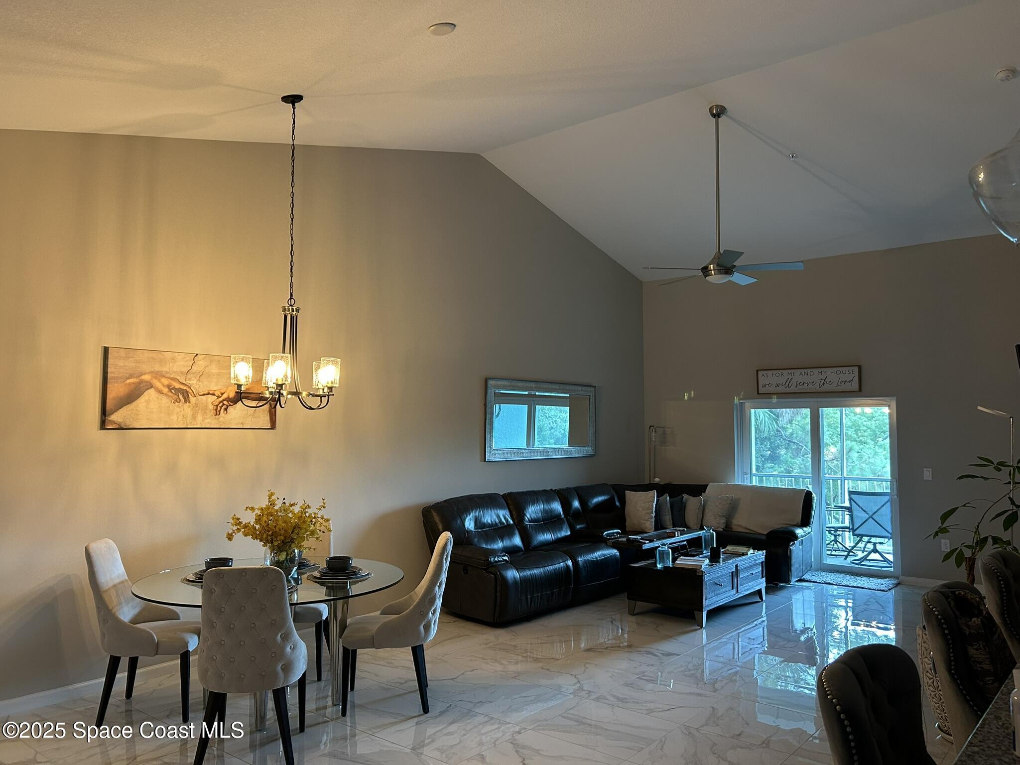 3931 Playa Del Sol Drive, Unit 203 Rockledge, FL 32955 - Photo 2 of 36 a living room with furniture a chandelier and a window