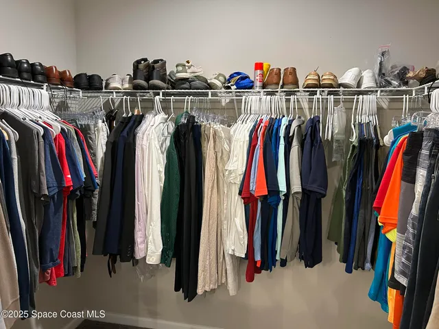 a bathroom with a granite countertop toilet sink and mirror