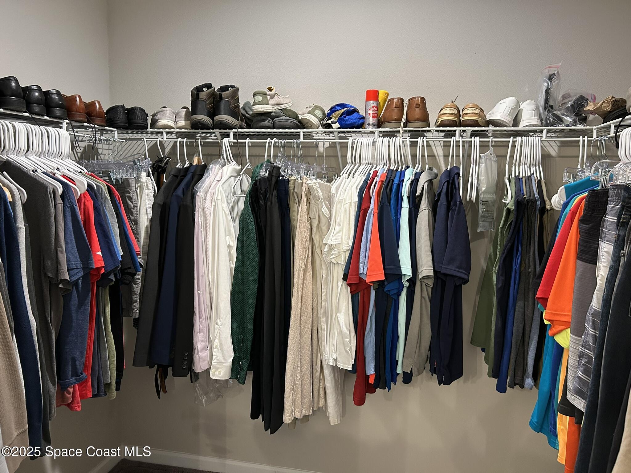3931 Playa Del Sol Drive, Unit 203 Rockledge, FL 32955 - Photo 22 of 36 a view of walk in closet with clothes and shoes