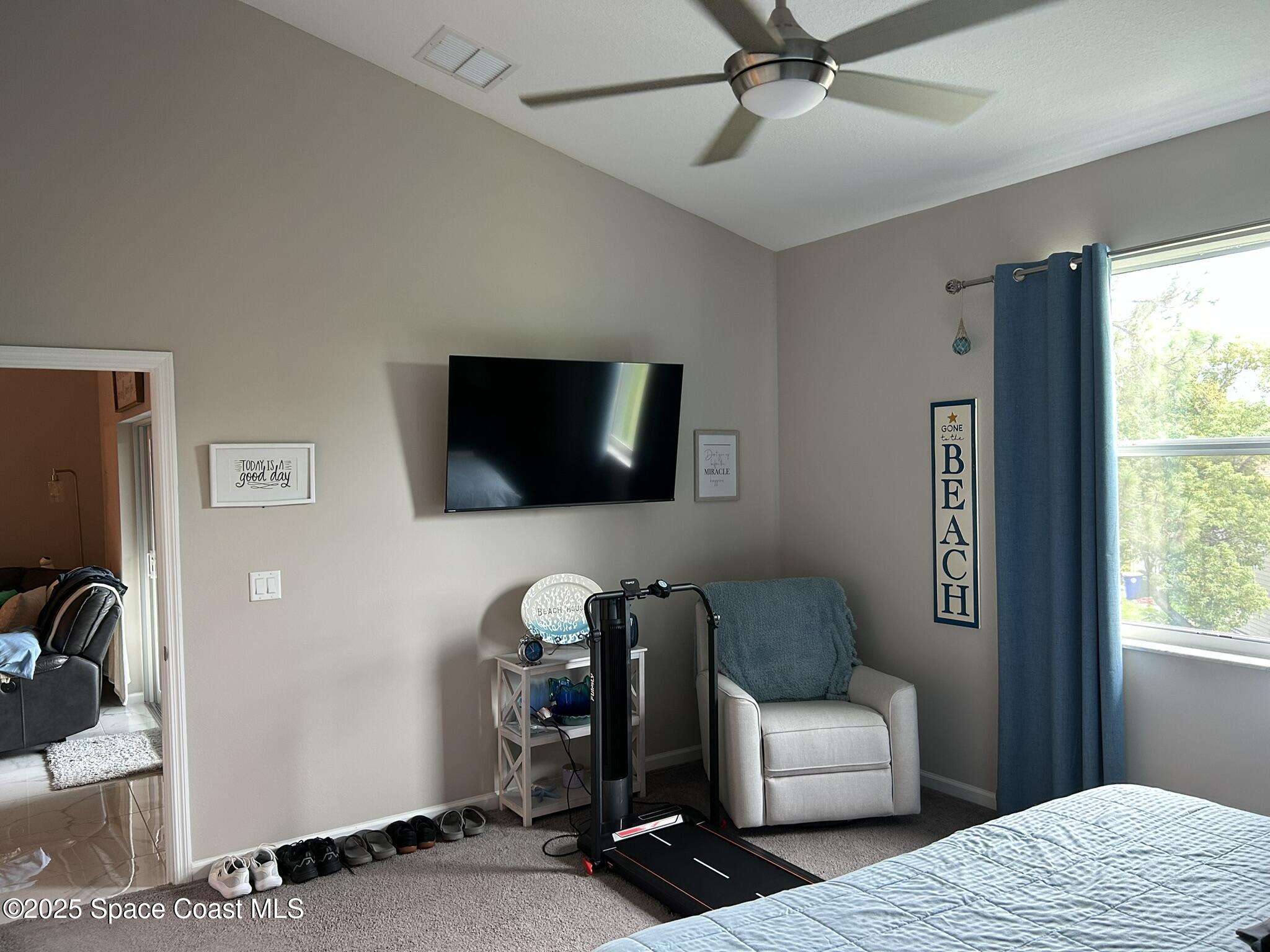 3931 Playa Del Sol Drive, Unit 203 Rockledge, FL 32955 - Photo 27 of 36 a living room with furniture and a flat screen tv