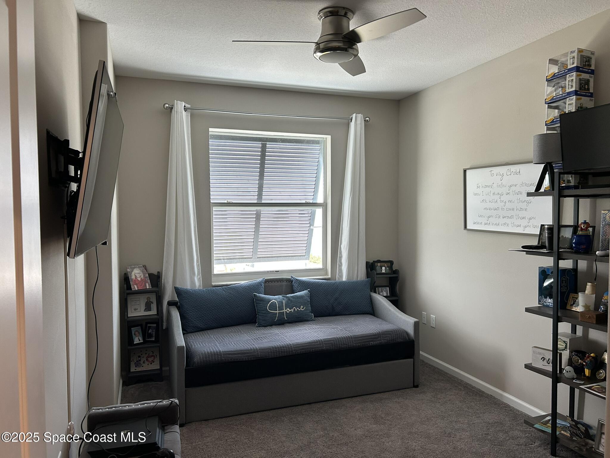 3931 Playa Del Sol Drive, Unit 203 Rockledge, FL 32955 - Photo 32 of 36 a living room with furniture and a window