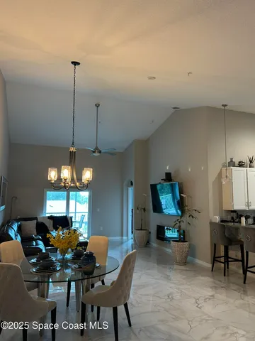 a dining room with furniture and window