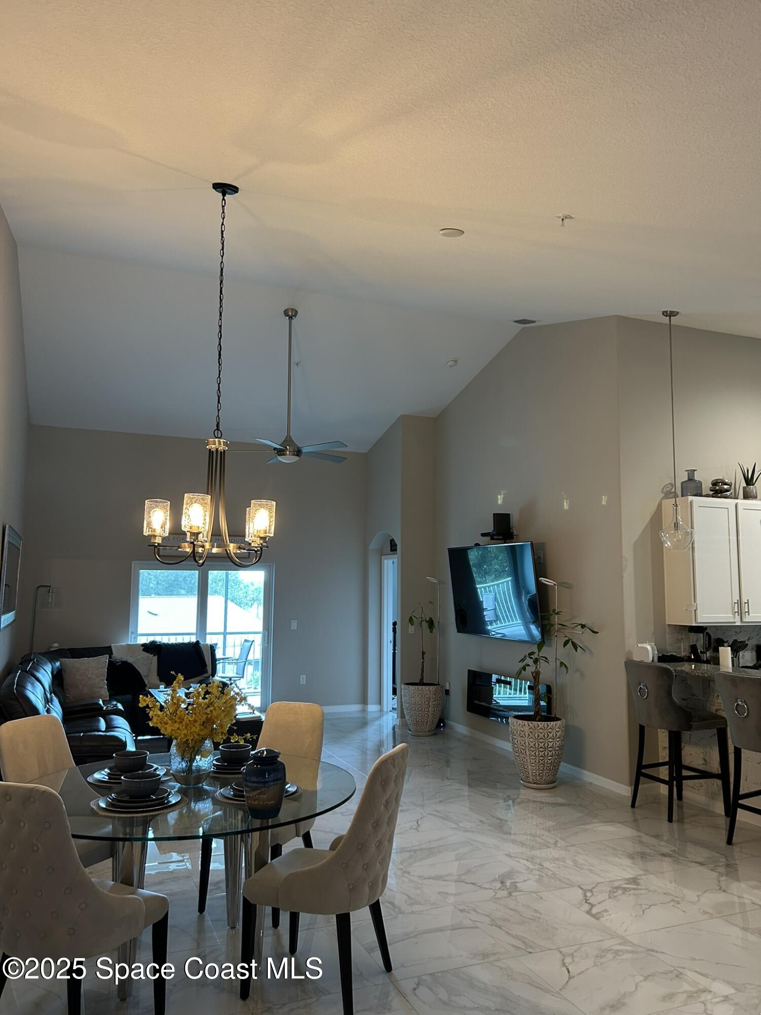 3931 Playa Del Sol Drive, Unit 203 Rockledge, FL 32955 - Photo 7 of 36 a dining room with furniture and window