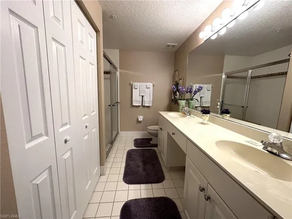 a bathroom with a sink a double vanity and shower
