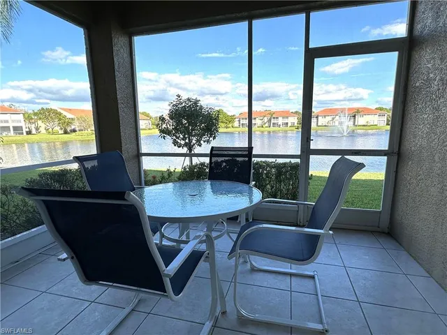 a view of a porch with furniture and a yard