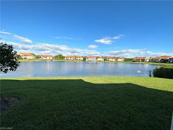 a view of a lake with houses in the back
