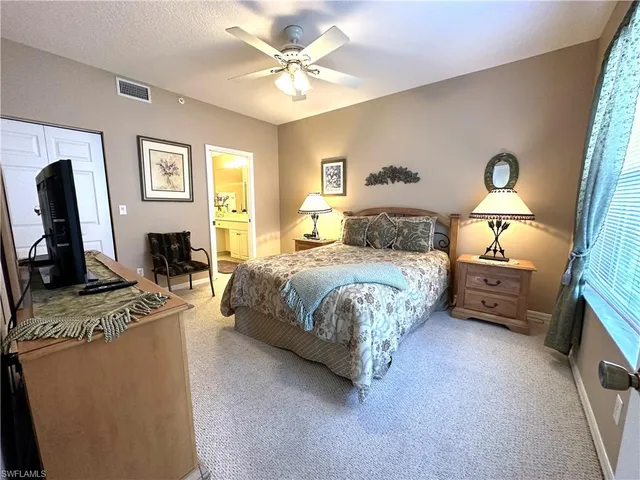 a bedroom with a bed a couch and dresser with wooden floor