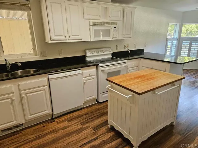a kitchen with wooden cabinets and a sink