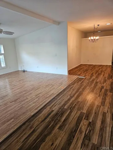 an empty room with wooden floor and closet