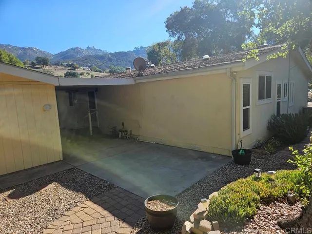 a view of a backyard with table and chairs
