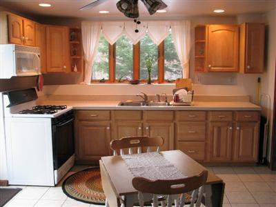 9 Josephs Road Truro, MA 02666 - Photo 12 of 14 a kitchen with a sink dining table and chairs