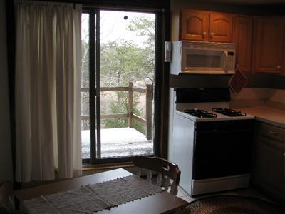 9 Josephs Road Truro, MA 02666 - Photo 13 of 14 a kitchen with a window a stove and a microwave