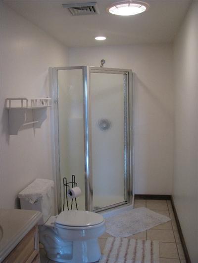 9 Josephs Road Truro, MA 02666 - Photo 14 of 14 a bathroom with a granite countertop sink a toilet a mirror and shower