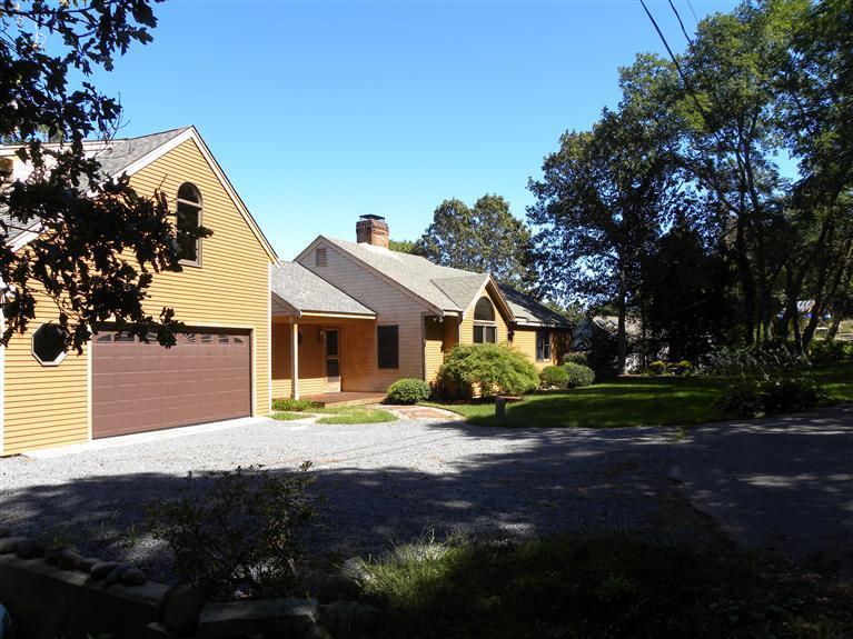 9 Josephs Road Truro, MA 02666 - Photo 2 of 14 a front view of a house with a yard and garage