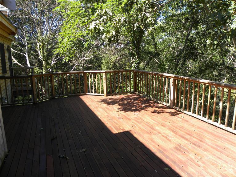 9 Josephs Road Truro, MA 02666 - Photo 9 of 14 a balcony with wooden floor and trees in the background