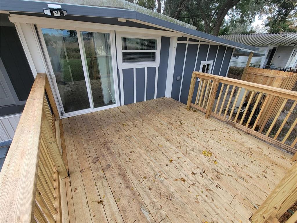 10895 Southeast Timucuan Road Summerfield, FL 34491 - Photo 16 of 23 a view of balcony with wooden floor