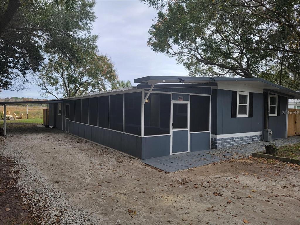 10895 Southeast Timucuan Road Summerfield, FL 34491 - Photo 2 of 23 a front view of a house with a yard and garage
