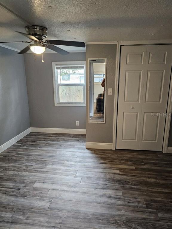 10895 Southeast Timucuan Road Summerfield, FL 34491 - Photo 6 of 23 a view of an empty room with wooden floor and a window