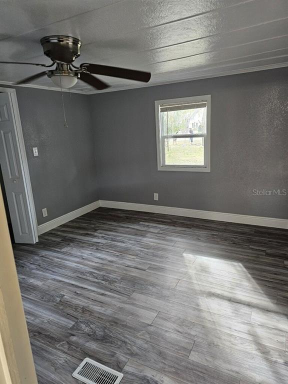 10895 Southeast Timucuan Road Summerfield, FL 34491 - Photo 7 of 23 a view of a room with wooden floor and window