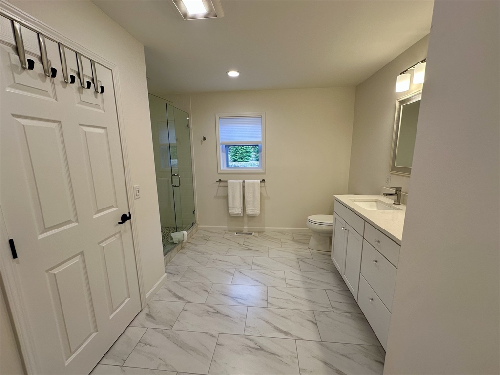 151 Tashmoo Avenue Tisbury, MA 02568 - Photo 15 of 28 a bathroom with a sink a toilet and a mirror