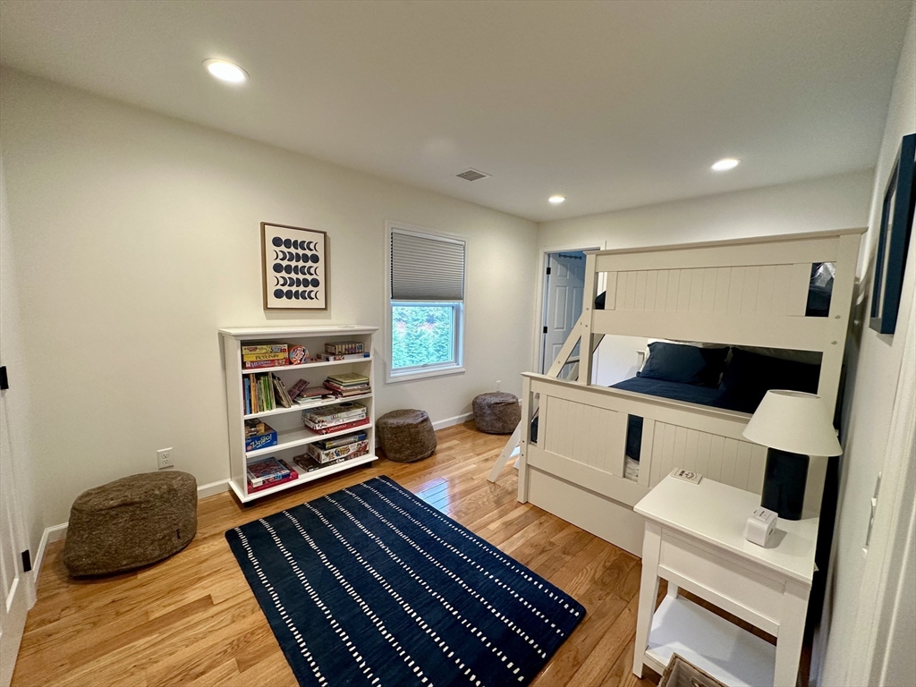 151 Tashmoo Avenue Tisbury, MA 02568 - Photo 22 of 28 a bedroom with furniture and a wooden floor