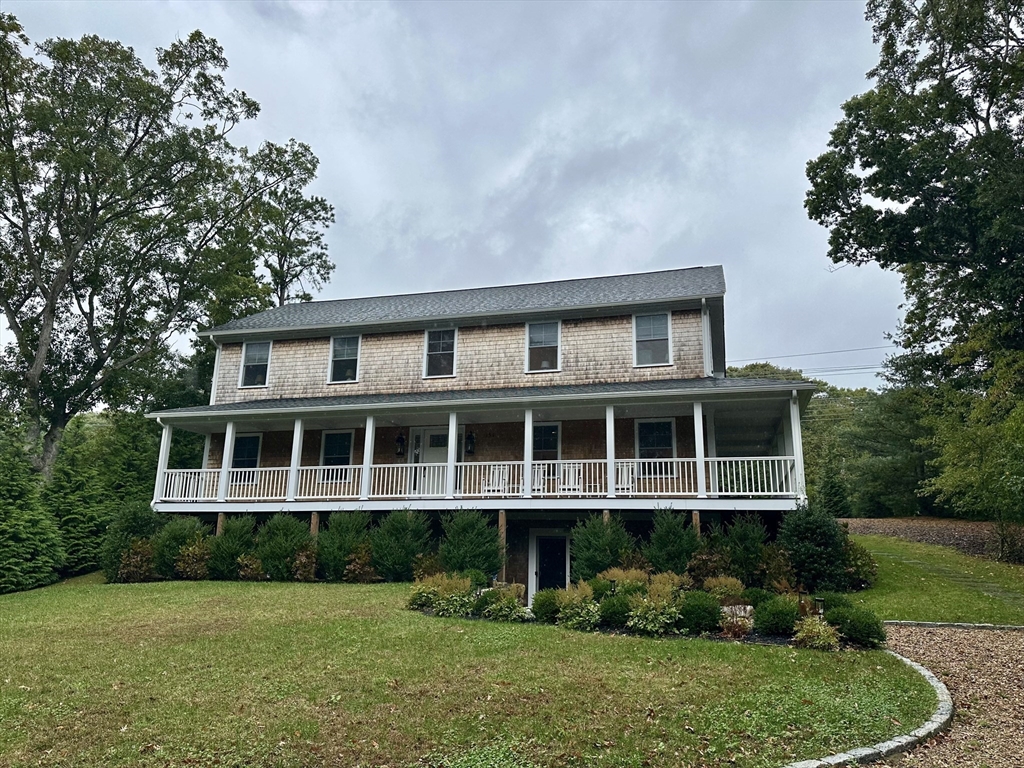 151 Tashmoo Avenue Tisbury, MA 02568 - Photo 28 of 28 a front view of a house with a yard and potted plants