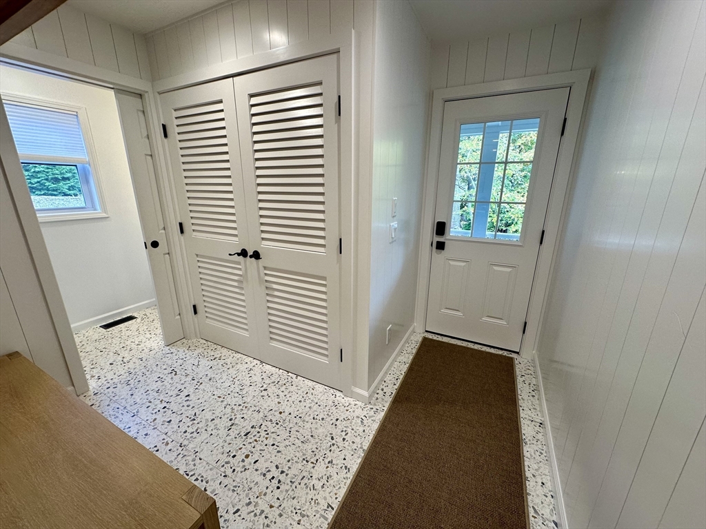 151 Tashmoo Avenue Tisbury, MA 02568 - Photo 5 of 28 a view of a hallway to rooms and stairs